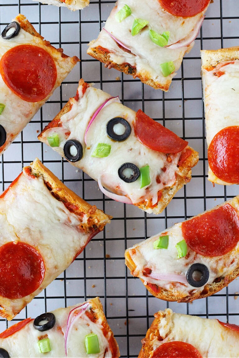 Overhead photo of garlic bread pizza slices on a cooling rack.