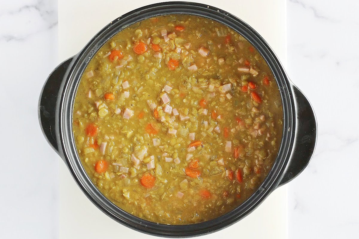 Overhead photo of the split pea soup with diced ham and veggies in a pot.