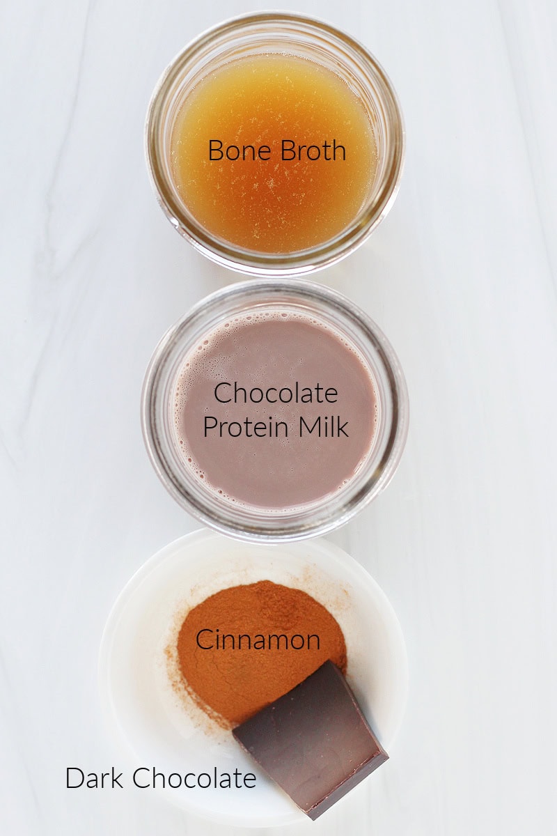 Labeled ingredients for bone broth hot chocolate on a white countertop.
