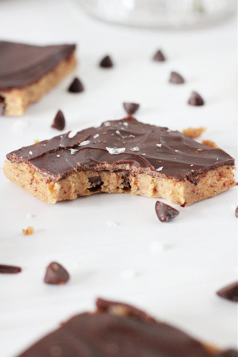 A piece of high protein cookie dough bark with mini chocolate chips and sea salt.
