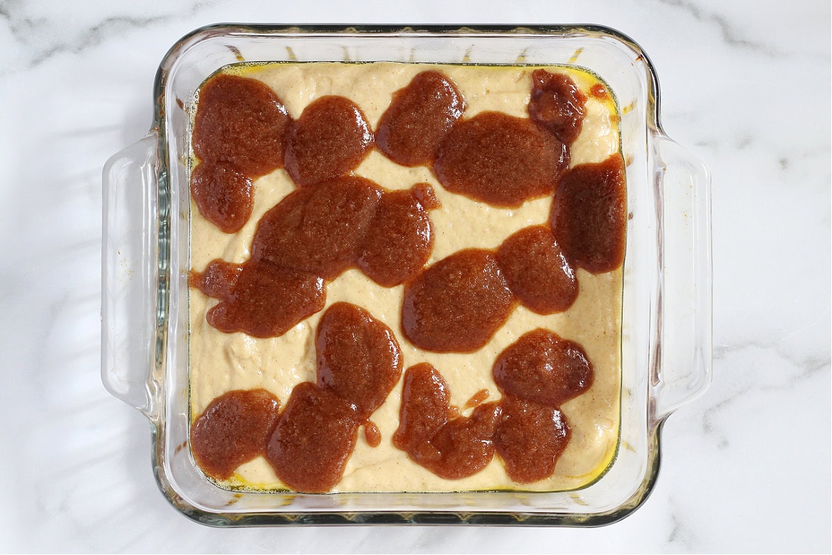 Cowboy bread batter in a pan with cinnamon sugar batter on top.