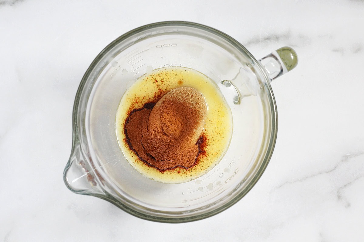 Melted butter, brown sugar and cinnamon in glass mixing bowl.