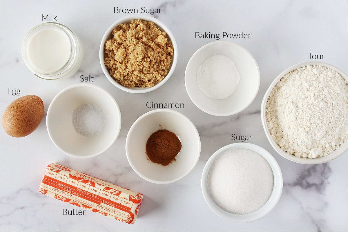 Labeled ingredients for cowboy bread on a white marble countertop.