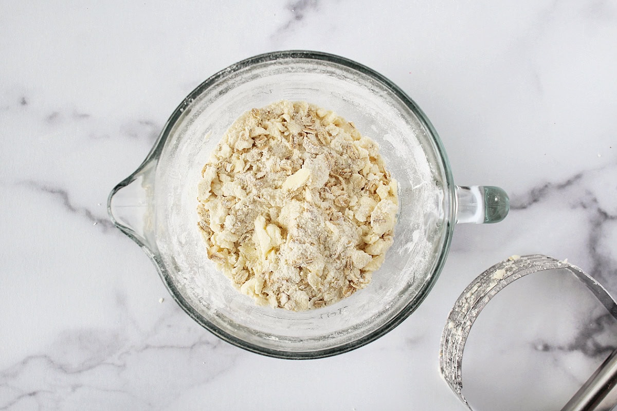 Streusel topping in a glass bowl mixed together with a pastry cutter.
