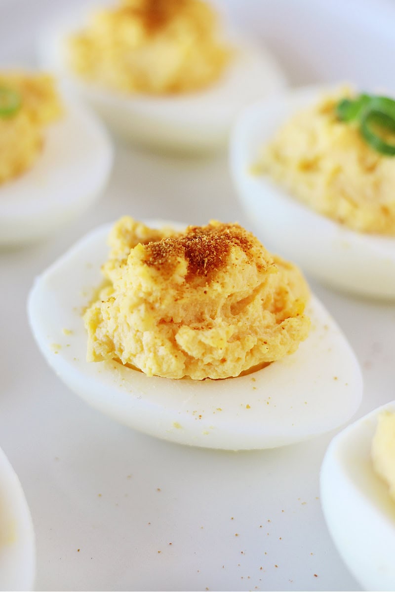 A hard boiled egg topped with paprika.