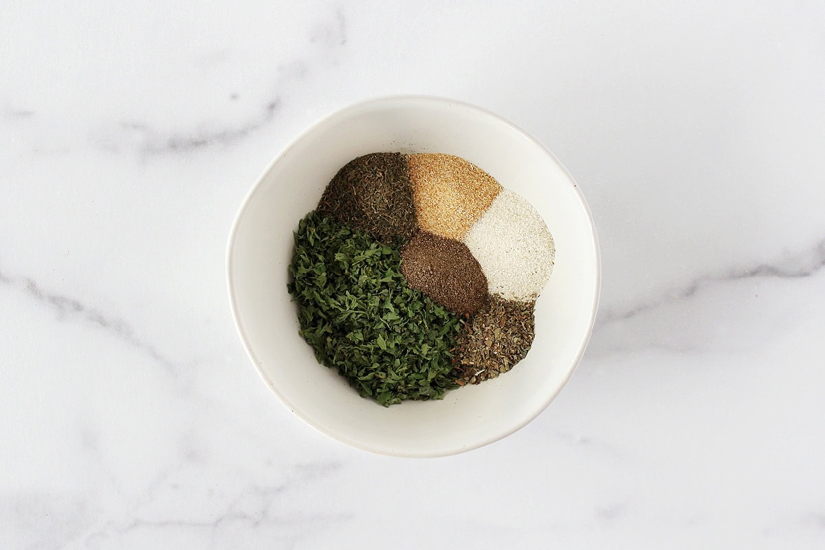 Dried herbs and seasonings in a small white bowl.