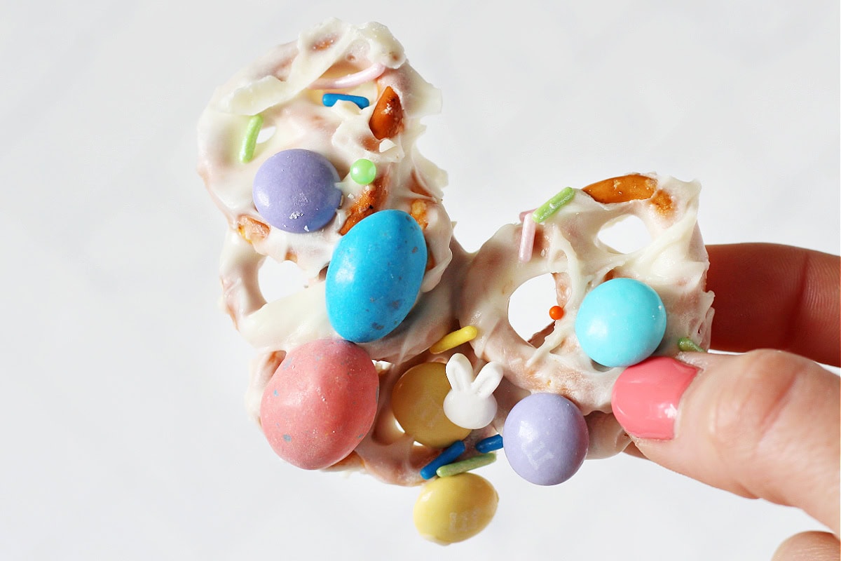 A piece of Easter candy pretzel bark with white bunny sprinkles.