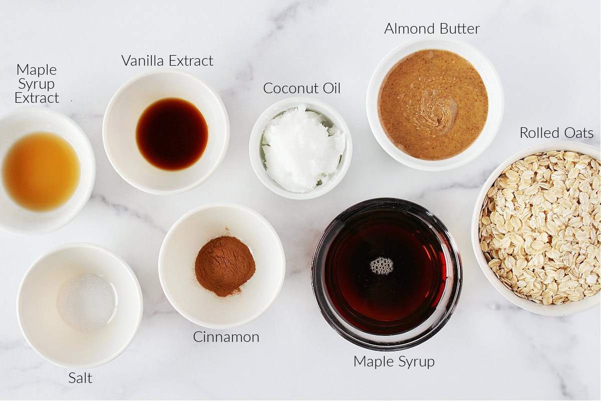 Labeled ingredients for French toast granola on a white marble countertop.