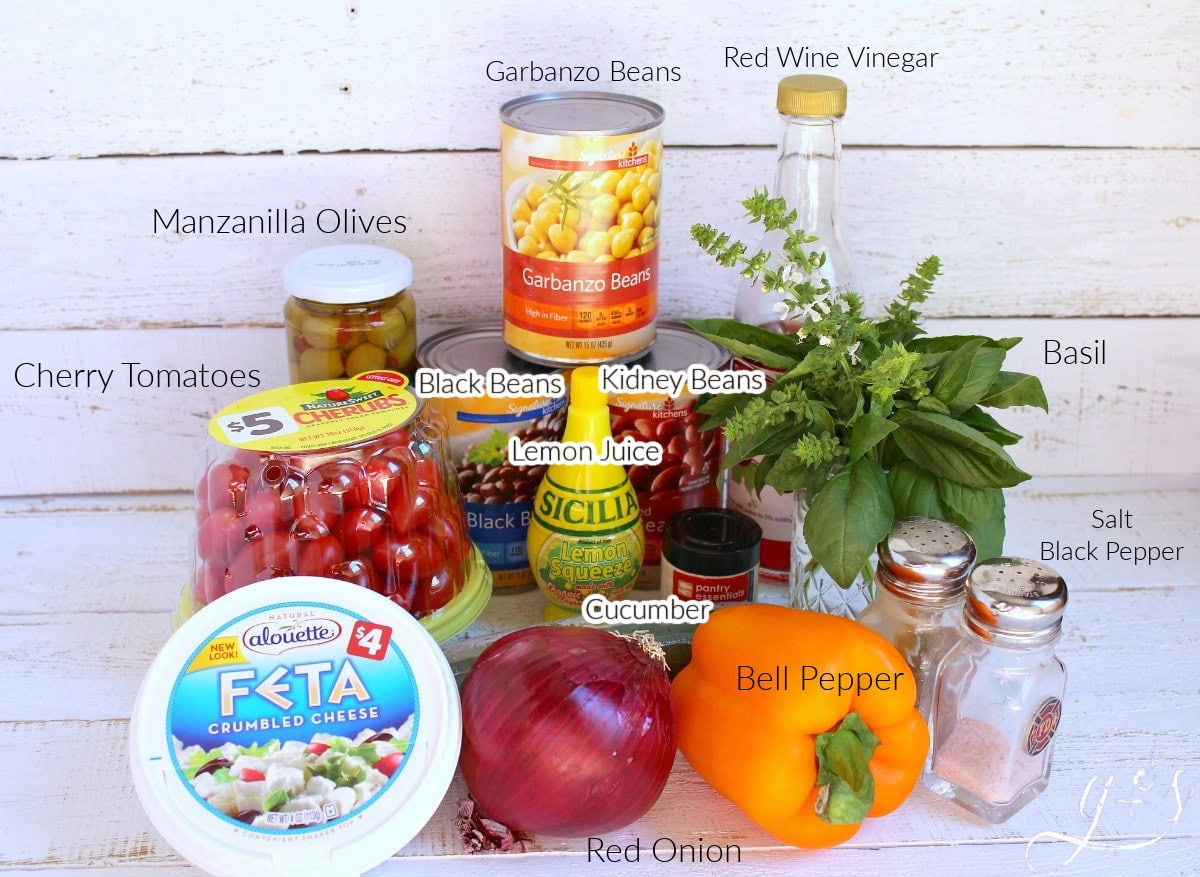 Labeled ingredients for Mediterranean Bean Salad with fresh basil and vegetables.