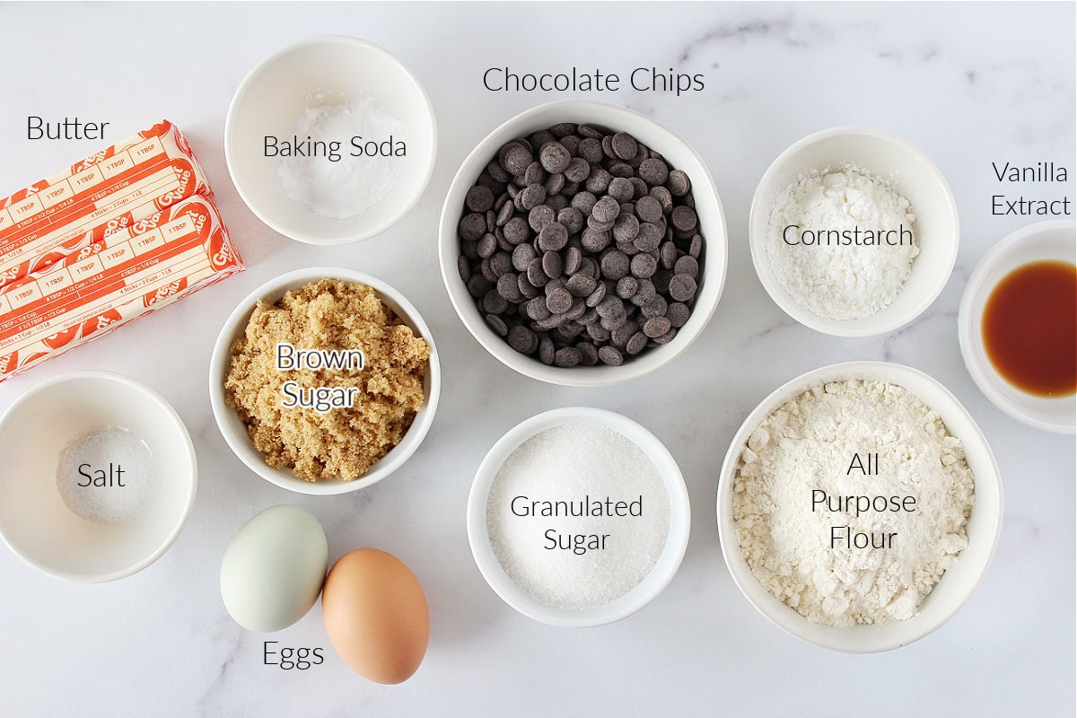 Labeled ingredients for one bowl chocolate chip cookies on a white marble countertop.