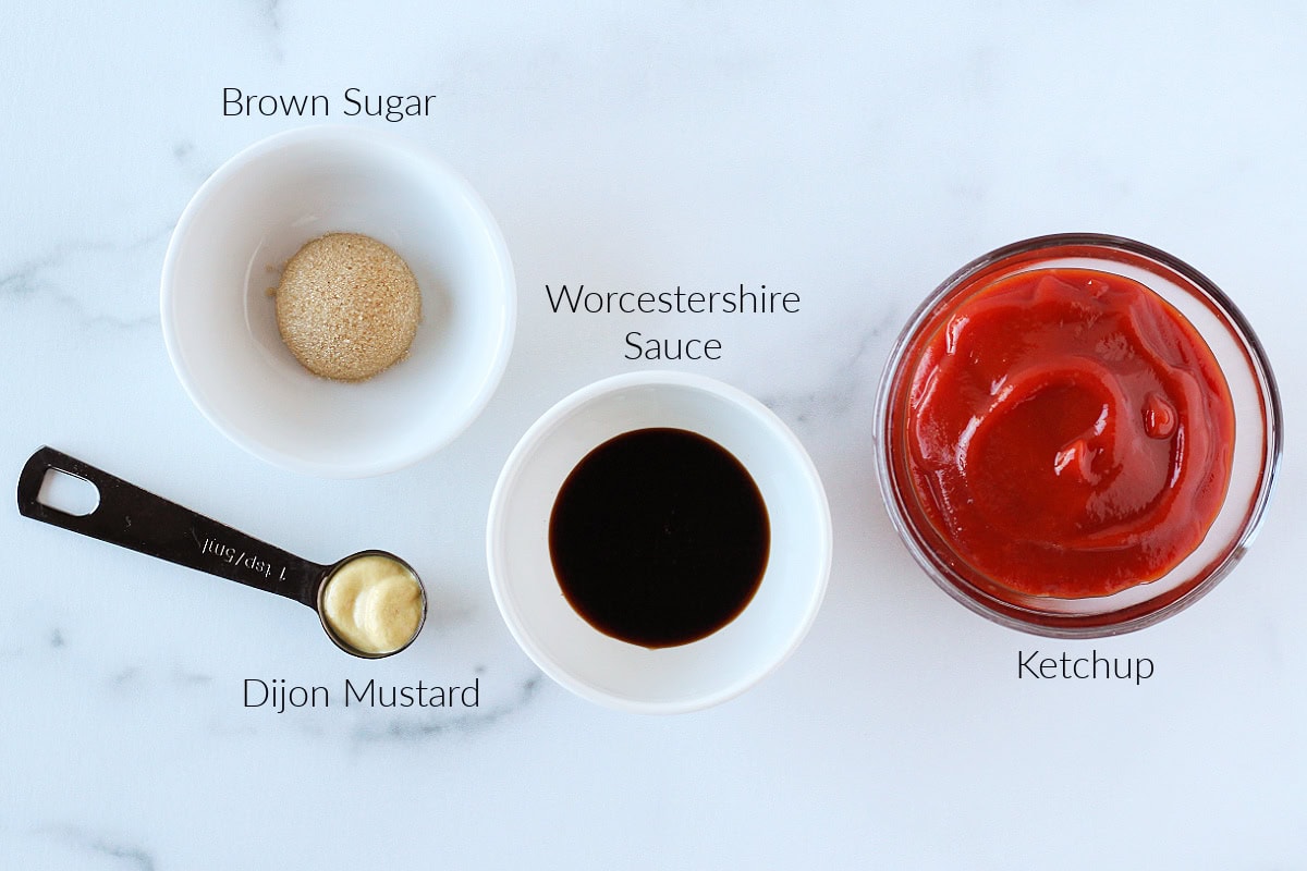 Labeled ingredients for ketchup sauce for meatloaf on a white marble countertop.