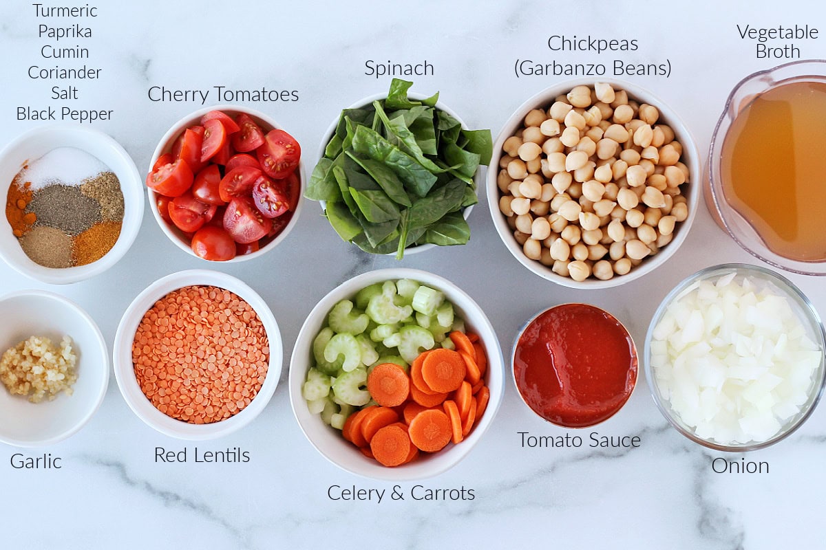 Labeled ingredients for Moroccan chickpea stew on a white marble countertop.