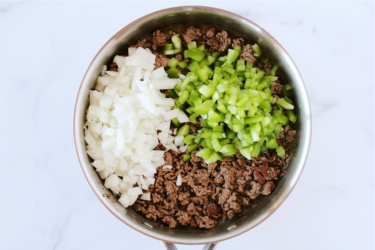 Browned ground beef, diced onion and green pepper in a sauté pan.