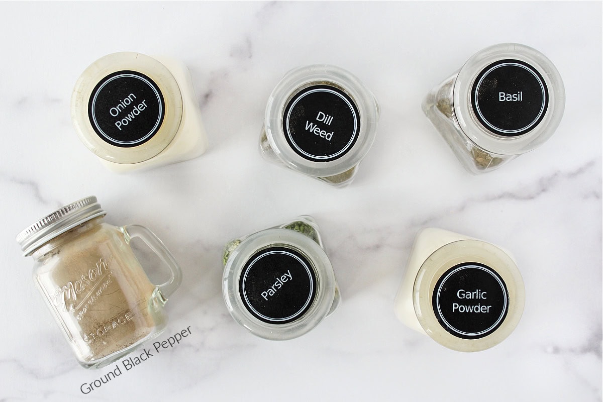 Labeled jars of dried spices for low sodium homemade ranch seasoning mix.