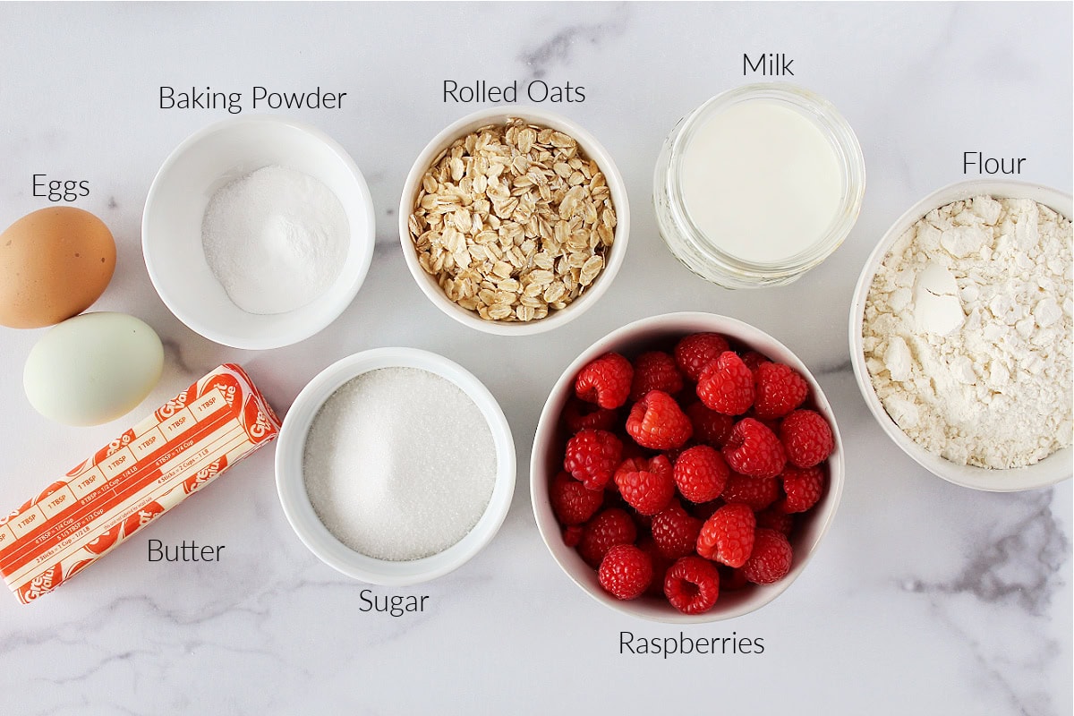 Labeled ingredients on a white marble countertop for raspberry coffee cake.