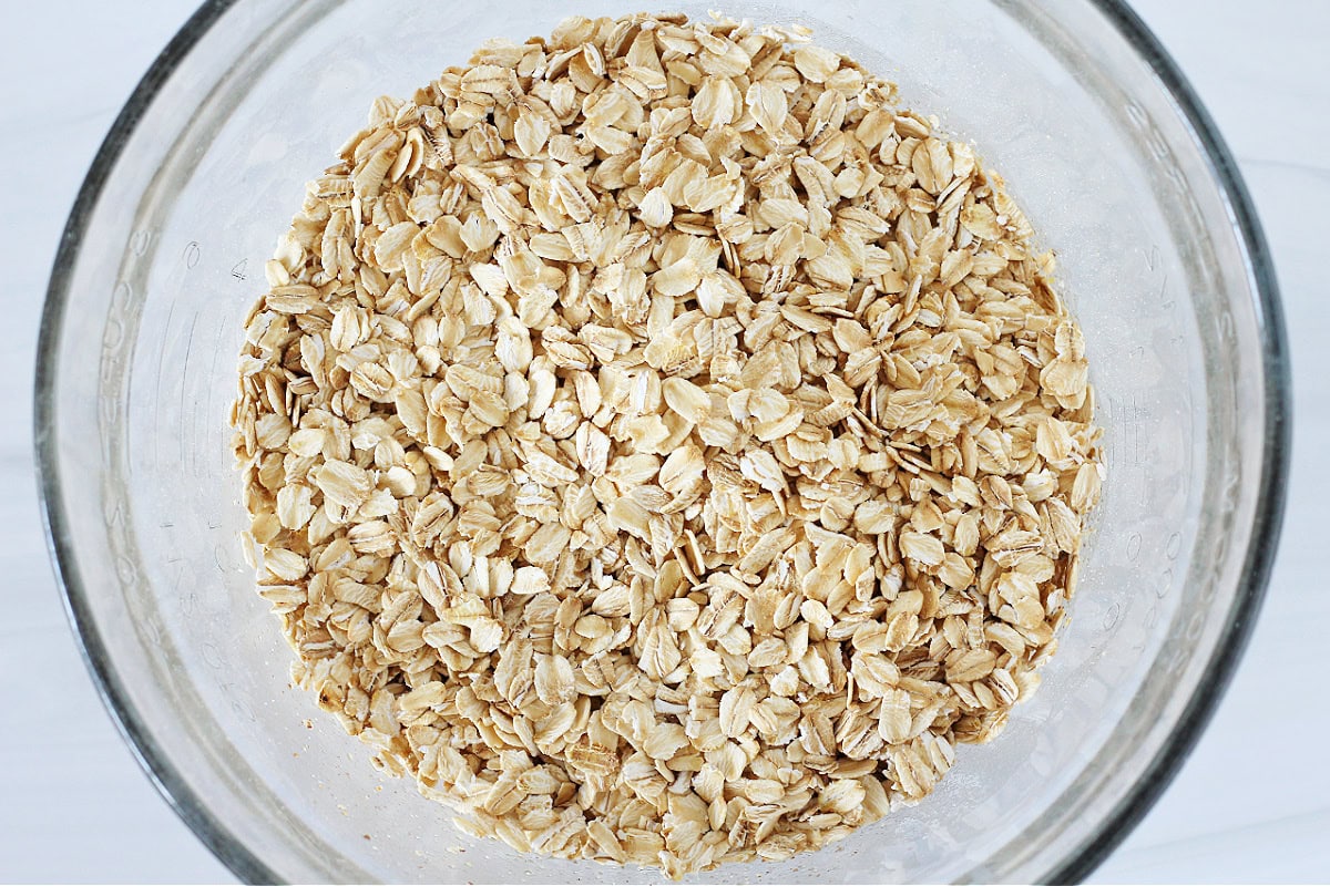 Rolled oats in a glass mixing bowl.