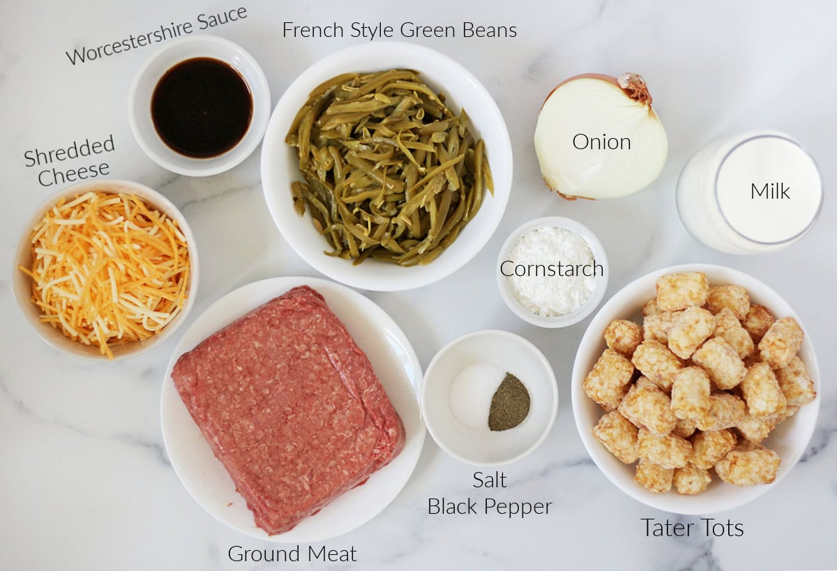 Labeled ingredients for tater tot casserole on a white marble countertop.