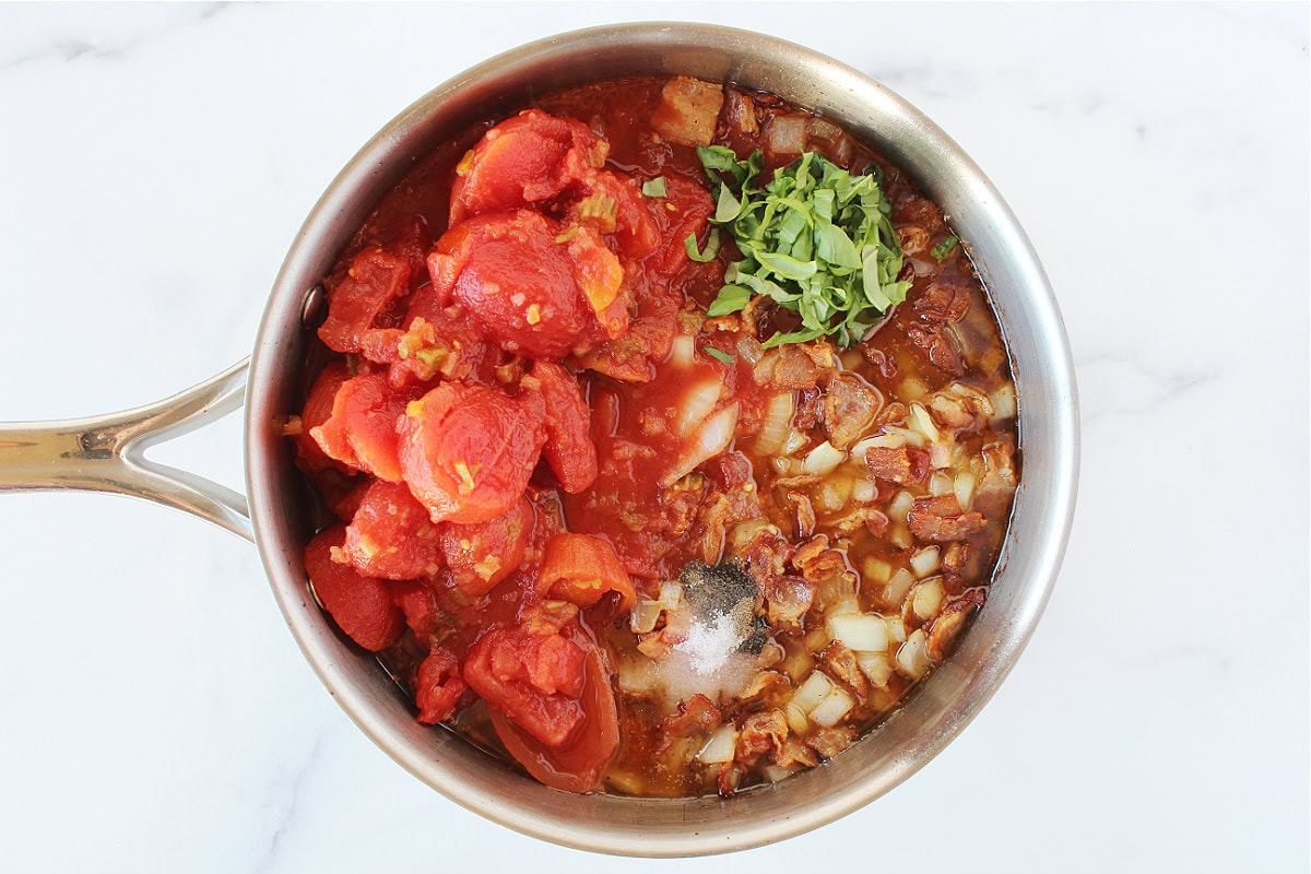 Stewed tomatoes, freshly chopped basil and seasonings in a bacon sauce.
