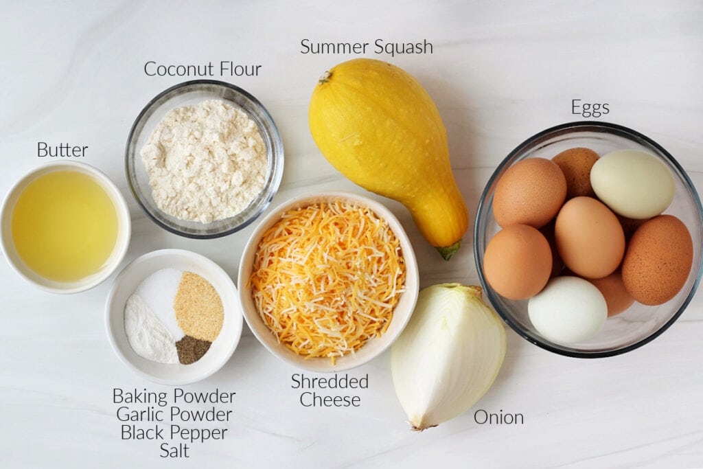Labeled ingredients for breakfast egg muffins on a white marble countertop.