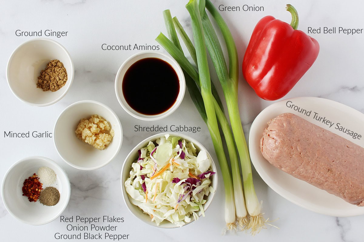 Labeled ingredients for easy egg roll in a bowl on a white marble countertop.