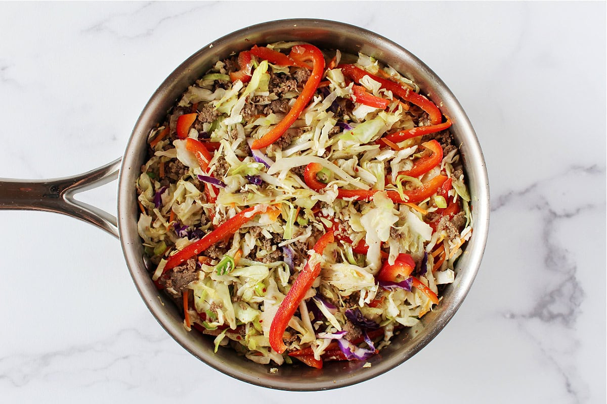 Deconstructed egg roll in a bowl in a sauté pan.