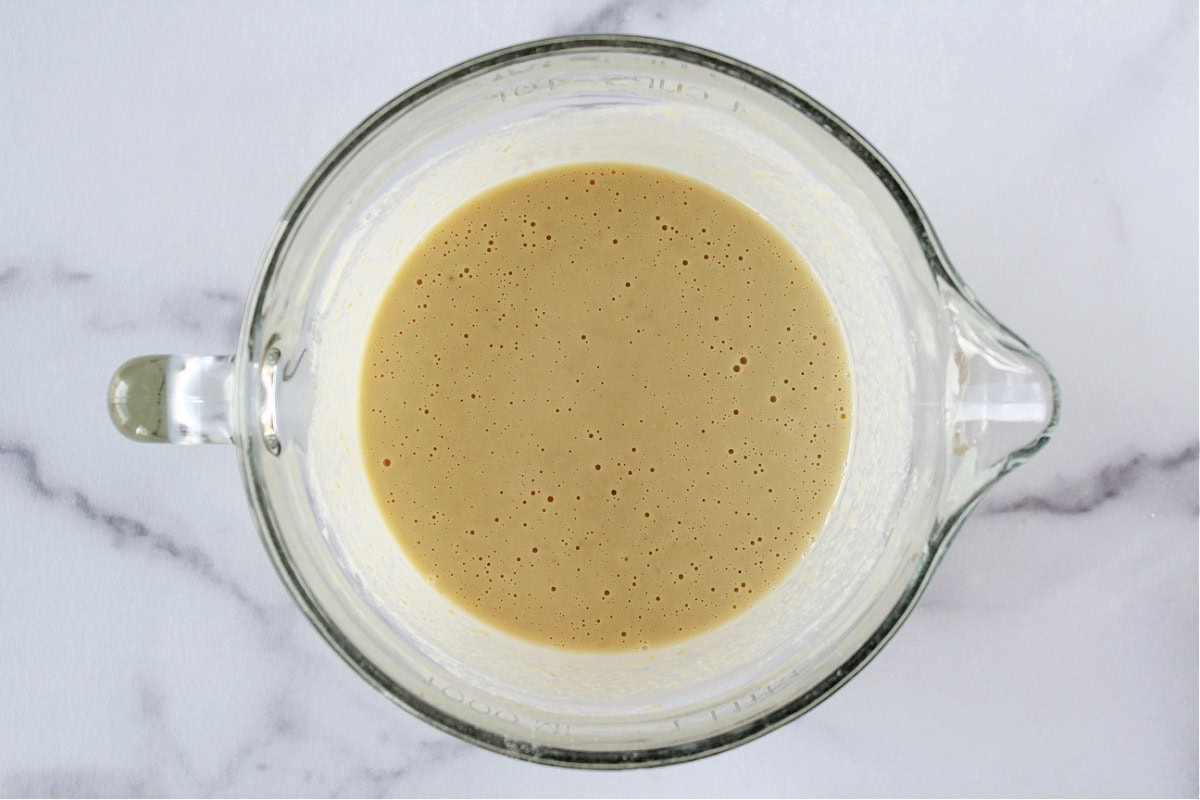 Pancake batter in a glass mixing bowl.