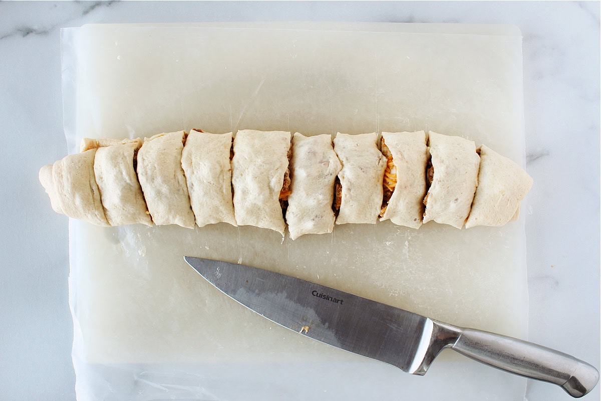 Crescent roll dough filled with sloppy joe mixture cut into ten slices.