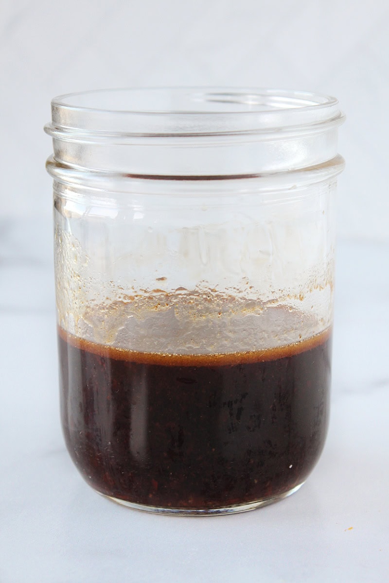 A brown Asian-inspired dressing in a mason jar.