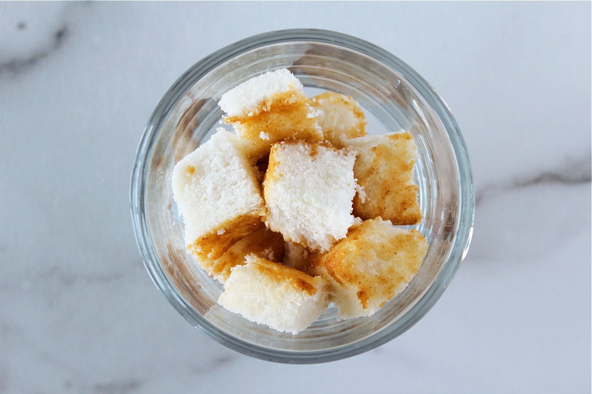 Cubes of angel food cake in a glass.