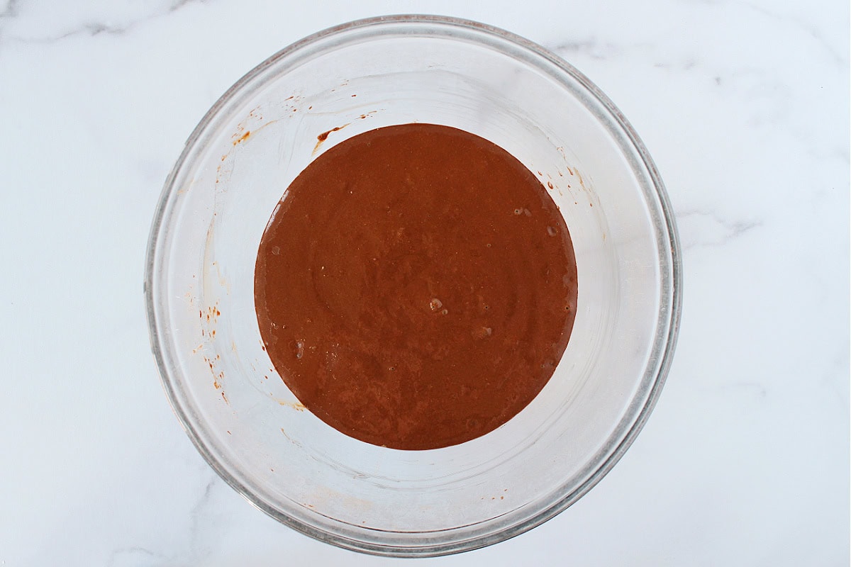 Brownie batter in a glass bowl.