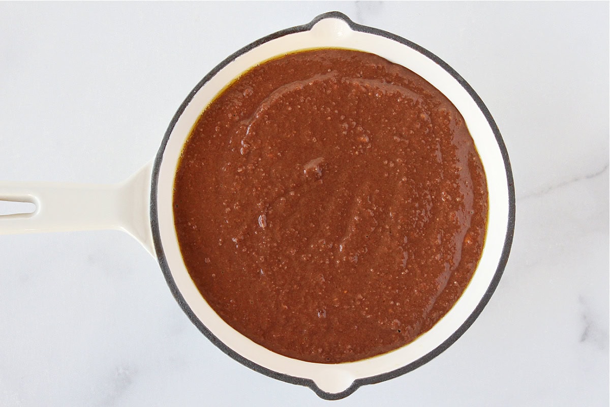 Chocolate cake batter in a glaze cast iron skillet.
