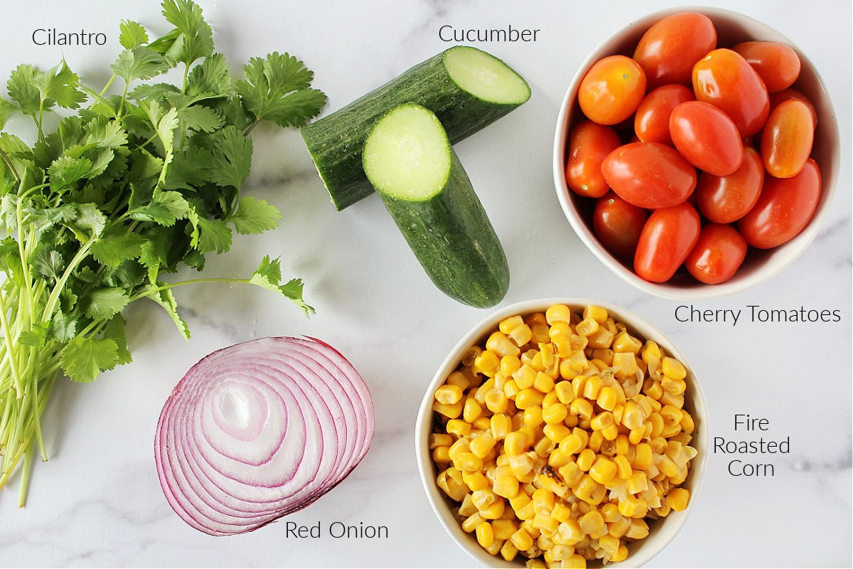 Labeled ingredients for zesty roasted corn salsa with cucumbers.