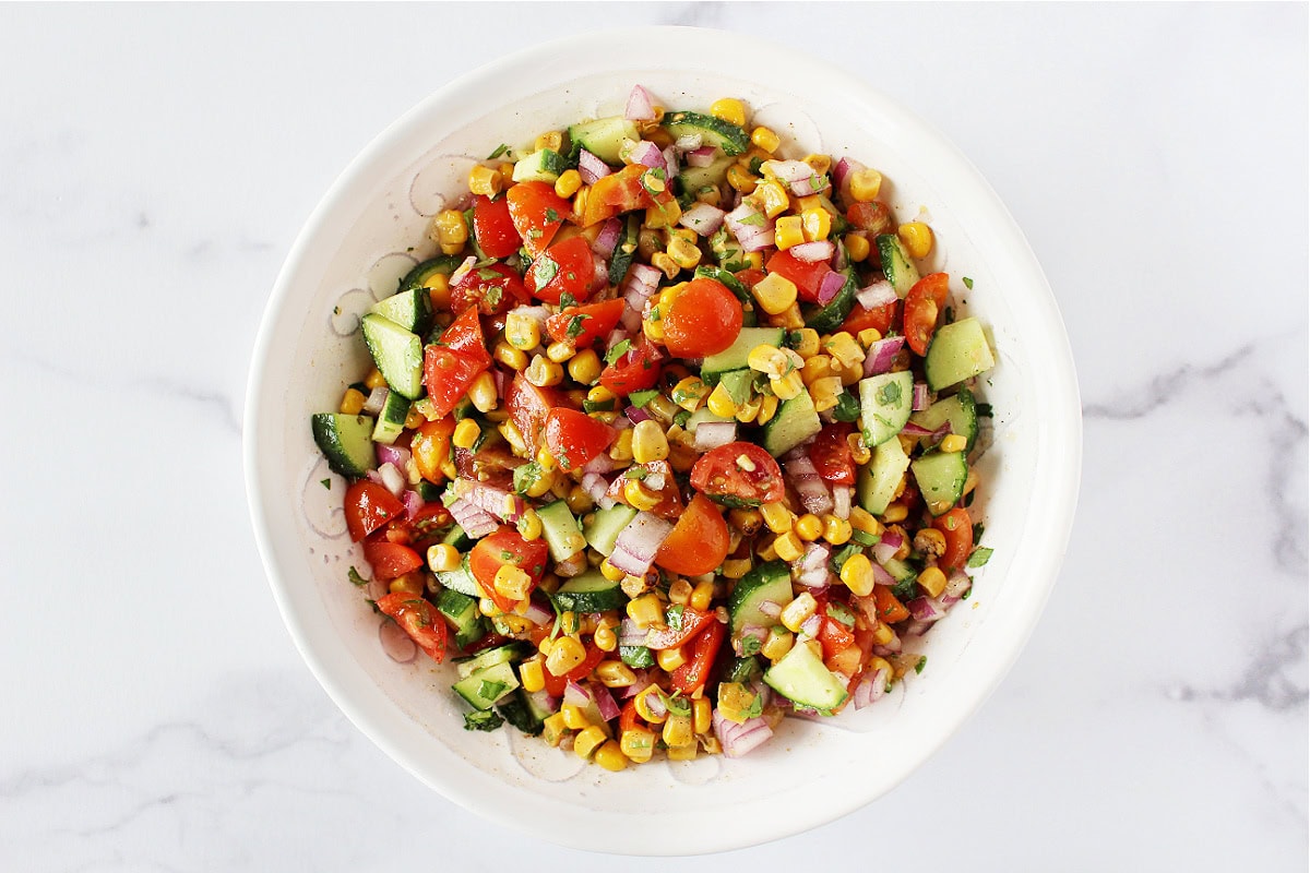 Roasted corn, cilantro, and fresh veggies in a lime cumin dressing.