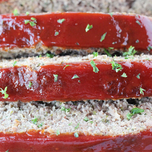 Three slices of meatloaf with ketchup glaze.