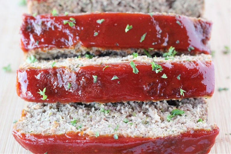 Three slices of meatloaf with ketchup glaze.