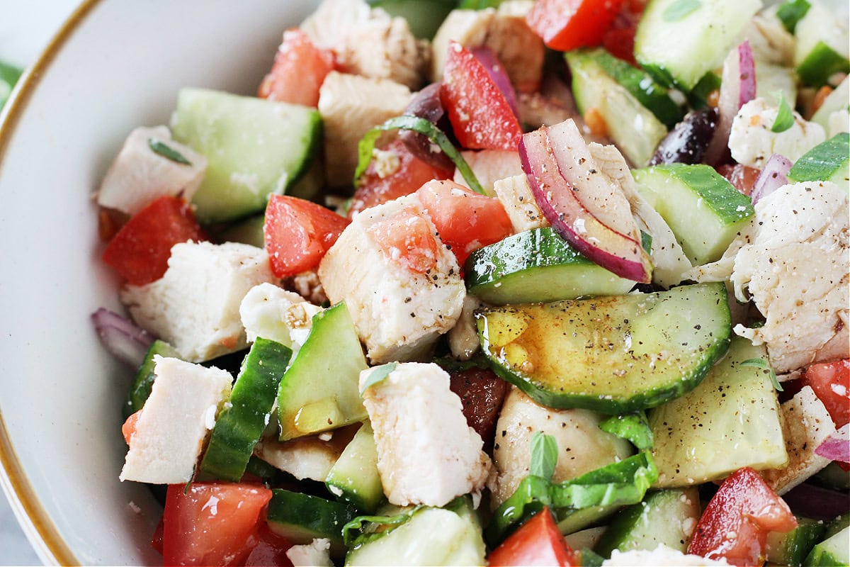 Grilled chicken in a fresh Greek salad with cucumber and tomato with a homemade dressing.