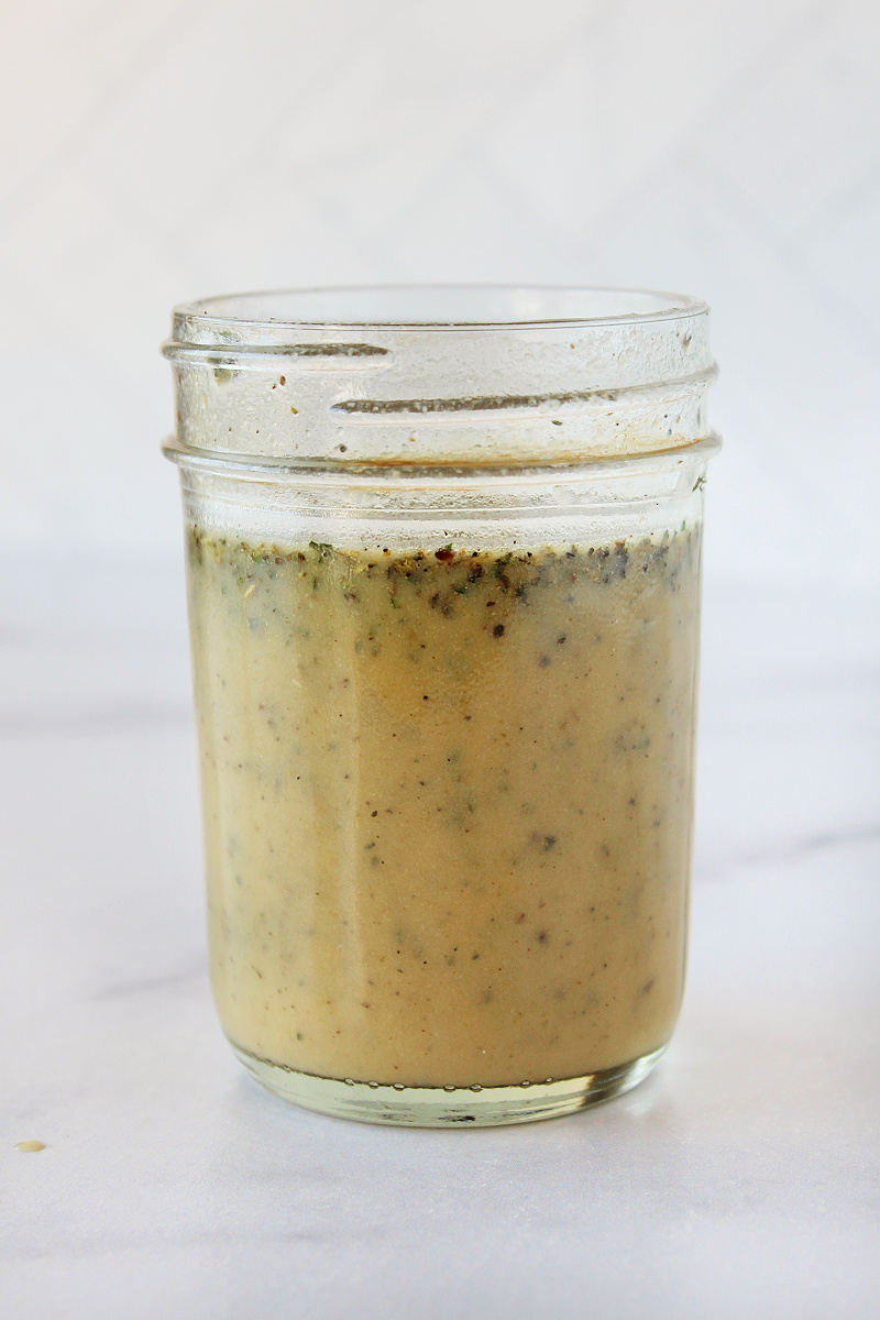 Homemade Italian dressing in a glass mason jar.