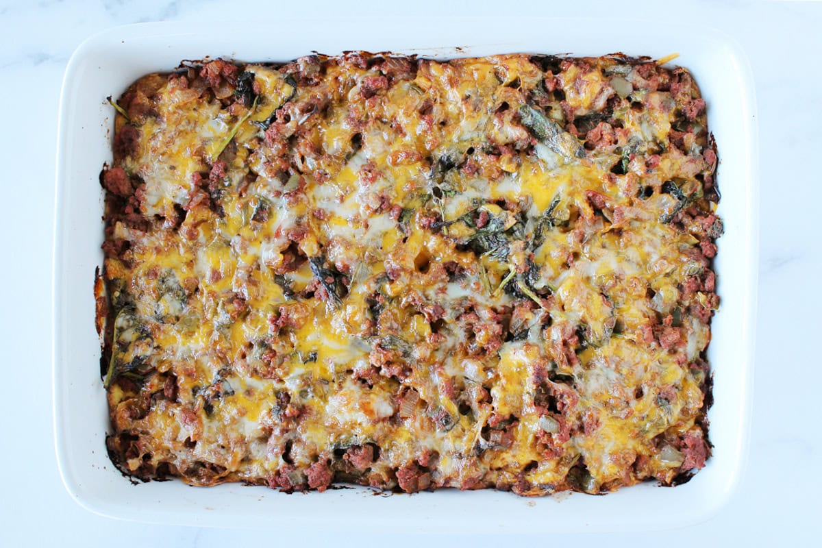 Baked Mexican cornbread casserole with melted cheese on top.