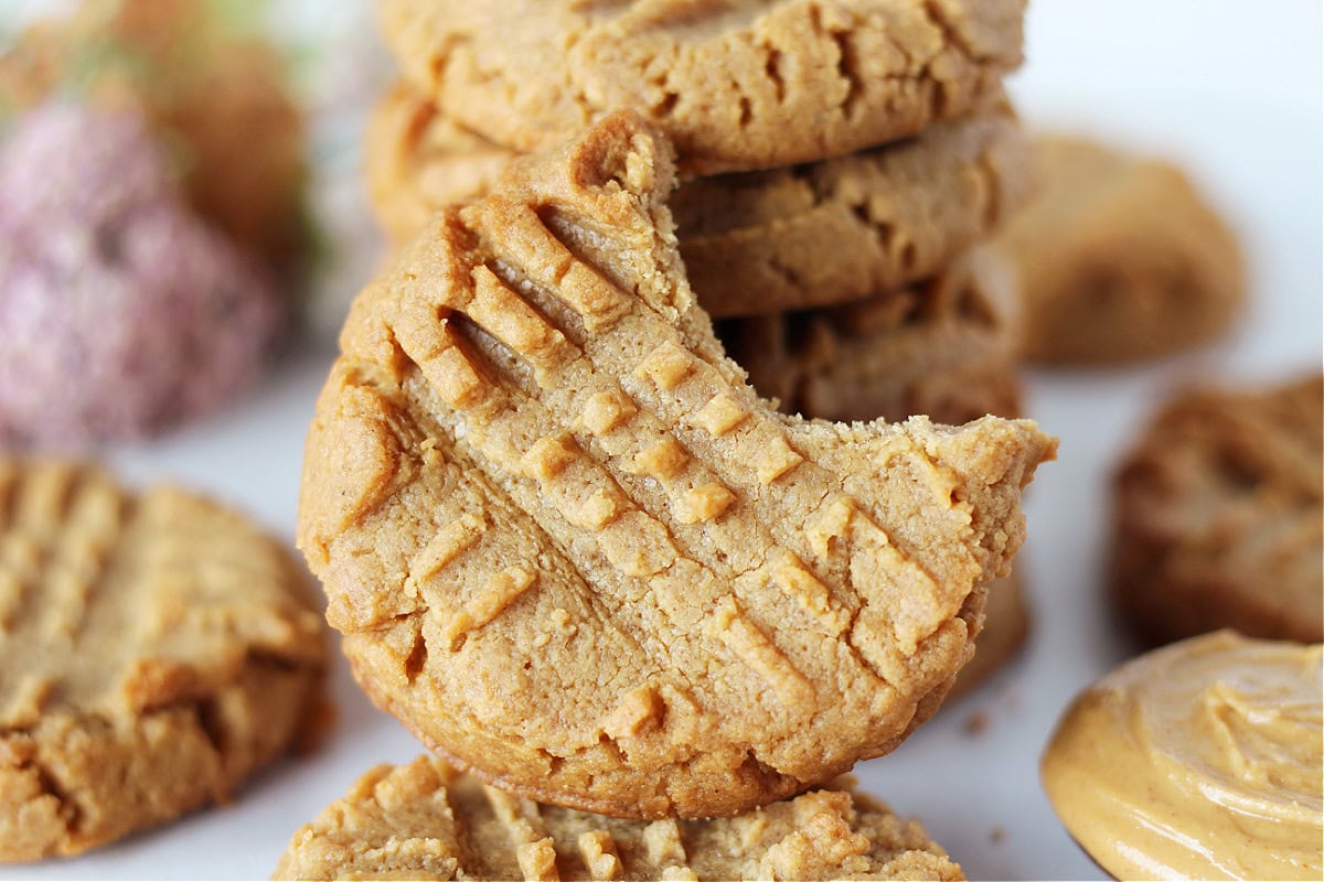 A bite taken out of a peanut butter cookie.