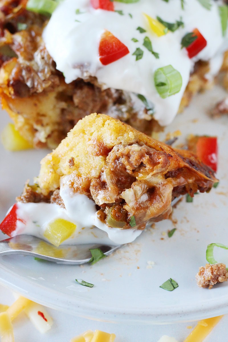 A fork with Mexican cornbread casserole on it.