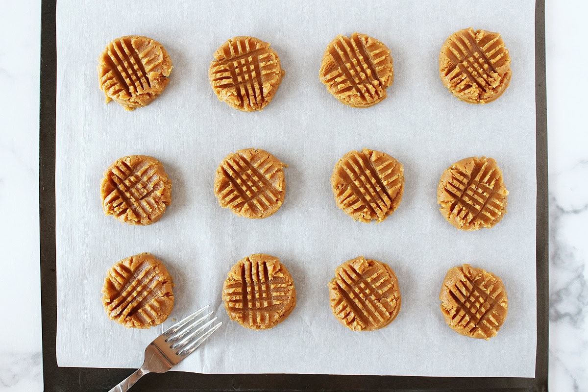 A crisscross pattern on each peanut butter cookie from a fork.