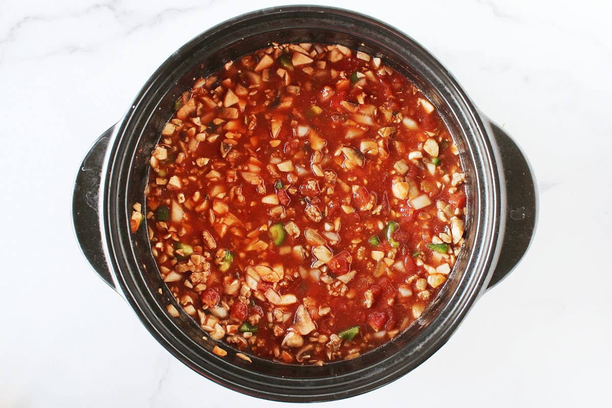 Chopped vegetables in a tomato sauce and diced tomato mixture.