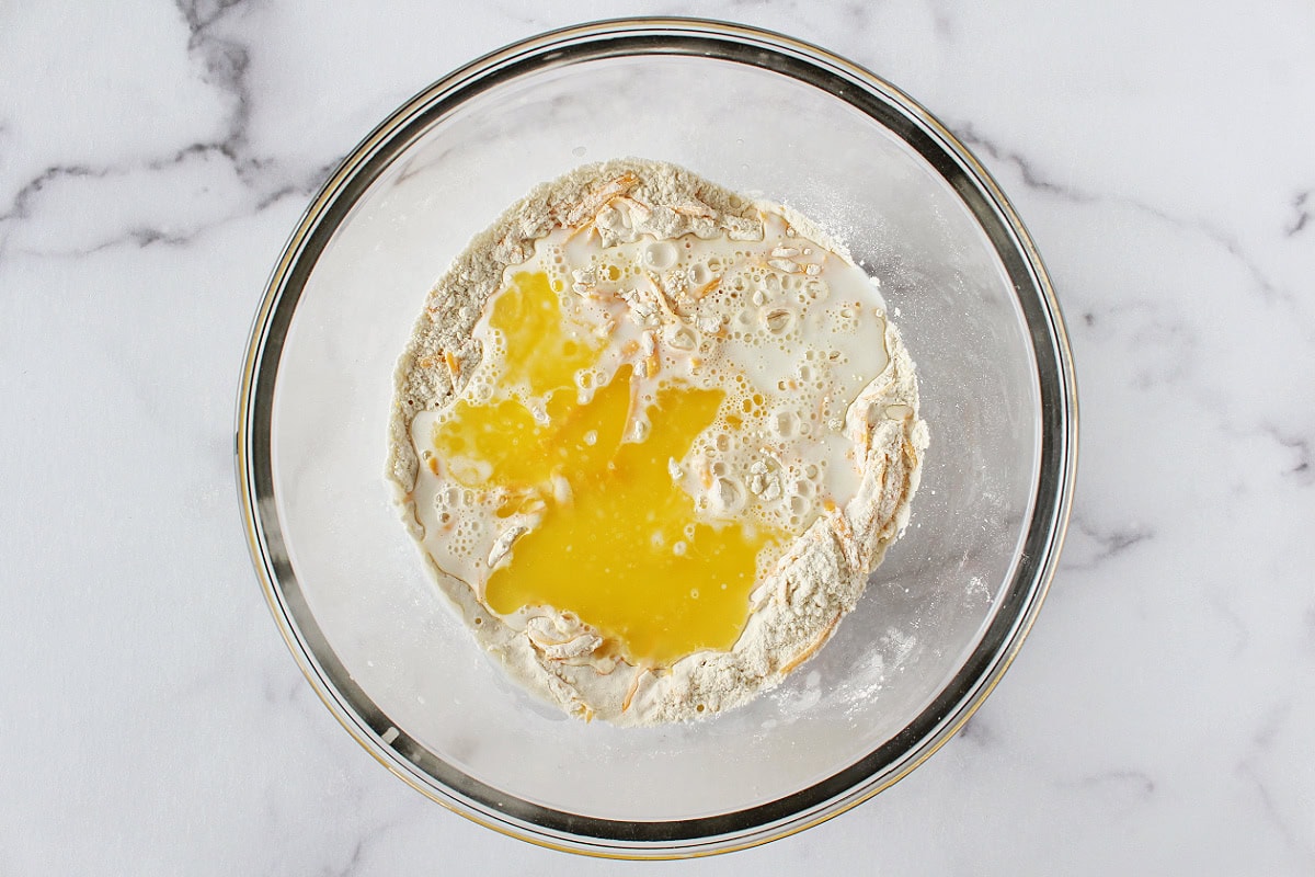 Melted butter and buttermilk in a mixing bowl of dry ingredients.
