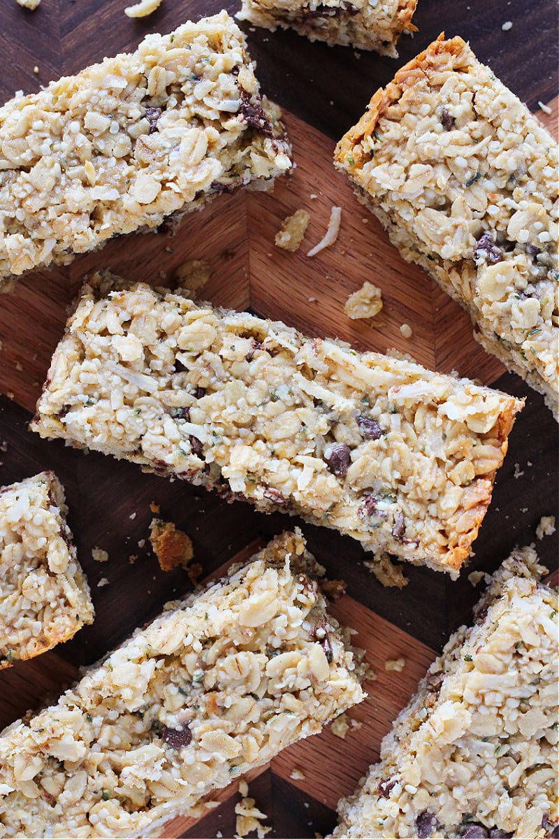 Granola bars with chocolate chips on a wooden cutting board.