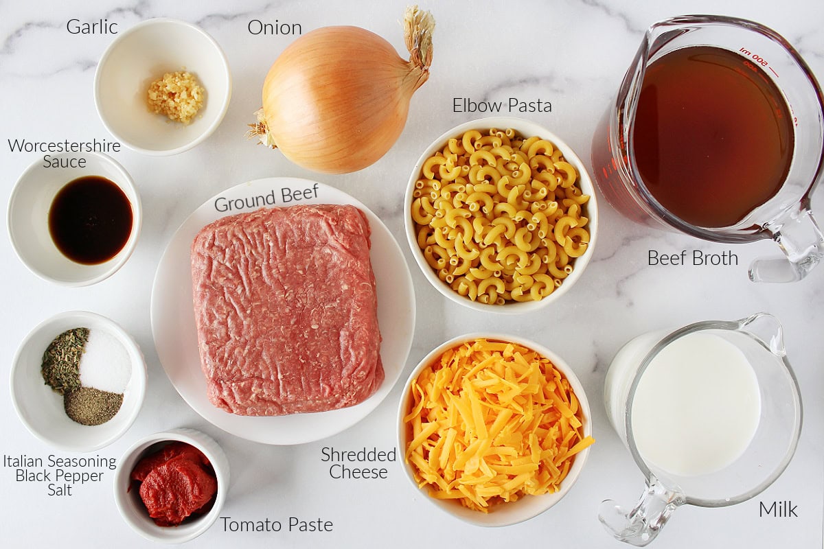 Labeled ingredients for homemade hamburger helper on a white marble countertop.