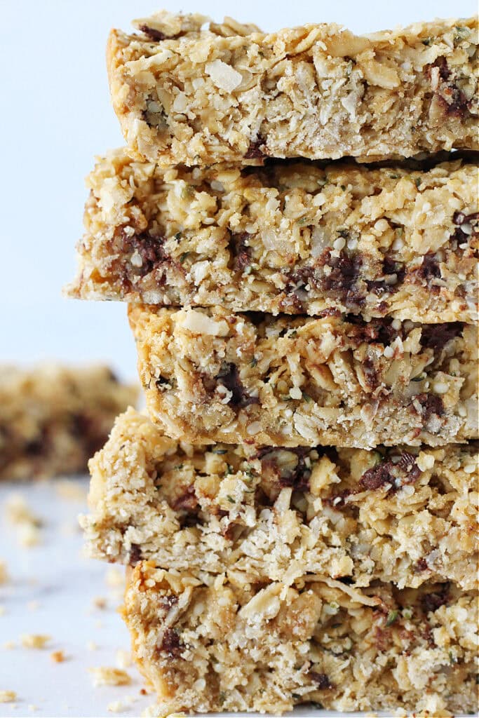 Five granola bars with hemp hearts and chocolate chips stacked on top of each other.