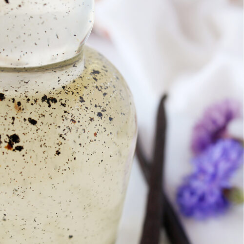 Flecks of vanilla bean in a bottle of homemade vanilla bean coffee syrup.