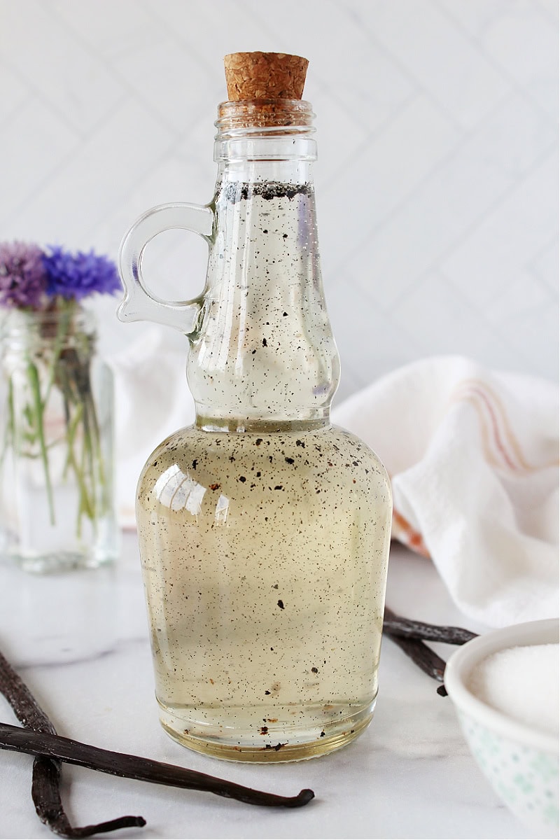 A glass bottle with a cork lid filled homemade vanilla coffee syrup.