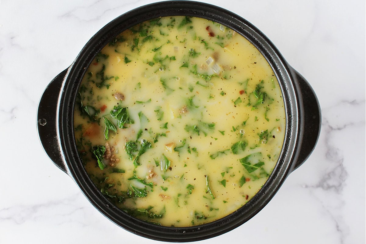 Softened kale, browned turkey sausage, and onion in a creamy broth.