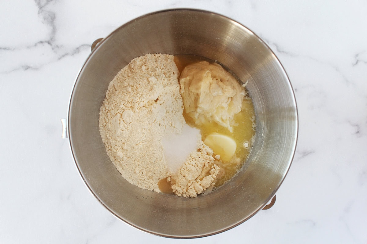 Flour, sourdough discard, butter, and salt in a metal stand mixer bowl.